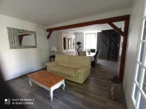 a living room with a couch and a table at La Providence in Chaumont