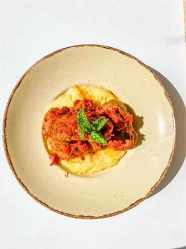 a plate of food with a piece of food on it at Mistral Boutique Hotel in Meganisi