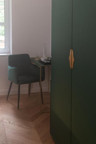 a room with a table and a chair next to a door at Hotel Starkl - Heritage & Unique in Bled