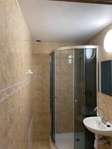 a bathroom with a shower and a sink at Relax in Polańczyk