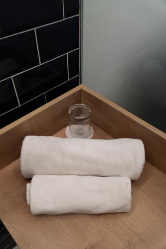 two rolls of towels sitting on top of a counter at Hotel Starkl - Heritage & Unique in Bled