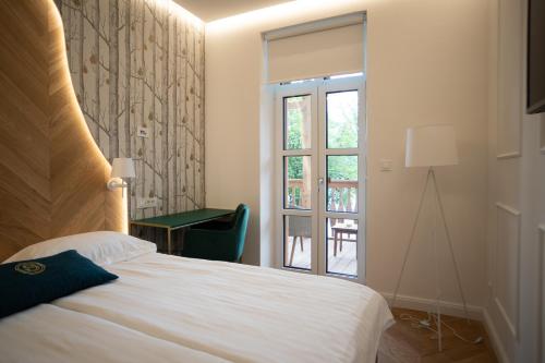 Säng eller sängar i ett rum på Hotel Starkl - Heritage & Unique