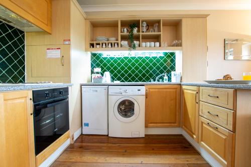 a kitchen with a washing machine and a dishwasher at 310 - The Carrowbeg at The Harbour Mills by Shortstays in Westport