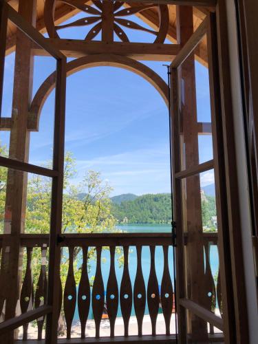 an open door to a balcony with a view of the water at Hotel Starkl - Heritage & Unique in Bled
