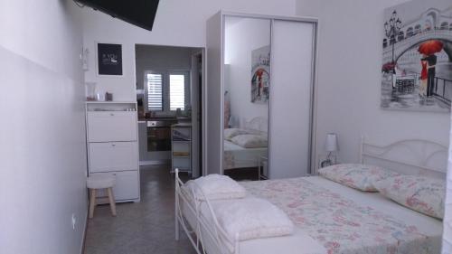 a white bedroom with a bed and a mirror at Swiss holiday 4 in Split