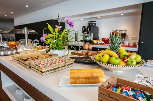 a buffet with various types of food on a counter at Hotel Restaurant Bonnet in Saint-Pée-sur-Nivelle