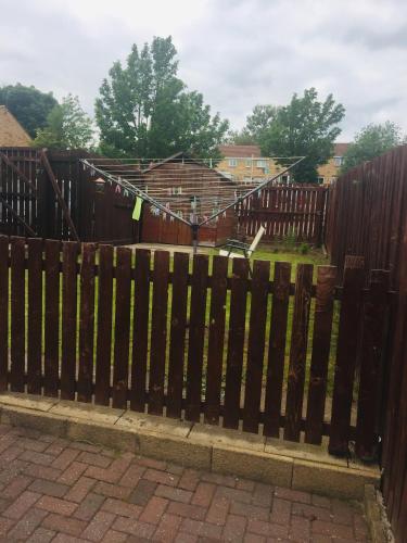 a wooden gate with a fence with a yard at LivingWater in Manor