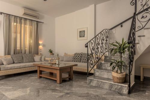 a living room with a couch and a table at Harbour Studios And Apartments in Palaiochóra