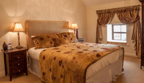 a bedroom with a large bed and a window at New Forest Estate Lodges in Tyrrellspass