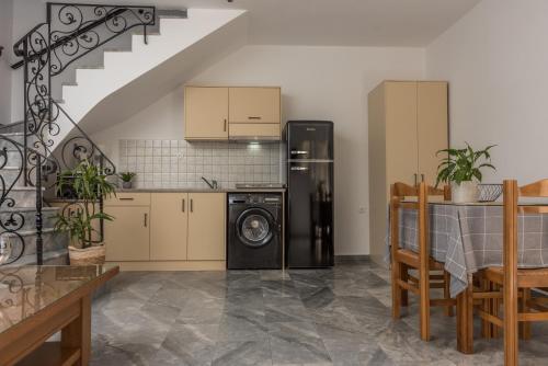 a kitchen with a black refrigerator and a dishwasher at Harbour Studios And Apartments in Palaiochóra