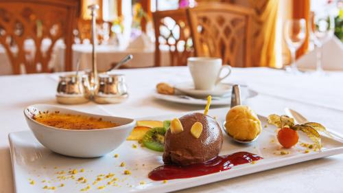 a plate of food on a table with a cup of coffee at Schwarzwaldhotel Oberwiesenhof in Seewald
