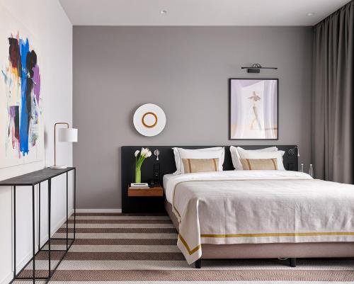 a bedroom with a large bed with white walls at B60 Hotel in Moscow