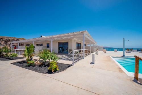 a house with a swimming pool and a resort at Etti - Paradise Suite La Gaviota in Pájara