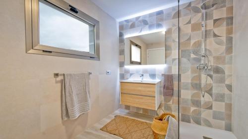 a bathroom with a shower and a sink at Etti - Paradise Suite La Gaviota in Pájara