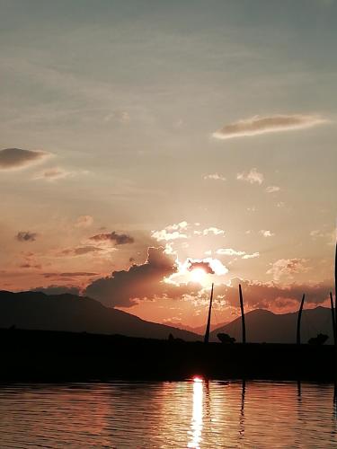 a sunset over a body of water at Apartement Flörl in Rohrberg