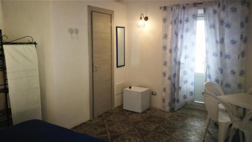a small room with a door and a window at Visitponza - La casa di Eolo in Ponza