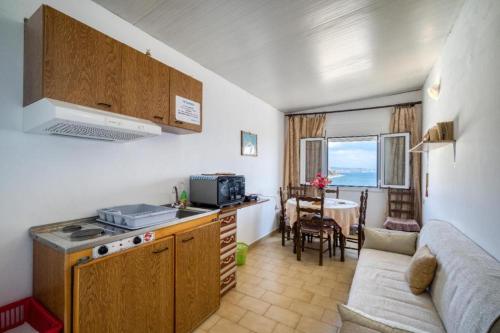 a kitchen and living room with a couch and a table at Lefteri's Rooms in Agia Galini