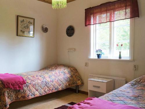 a bedroom with two beds and a window at 6 person holiday home in ÅSARP-By Traum in Åsarp