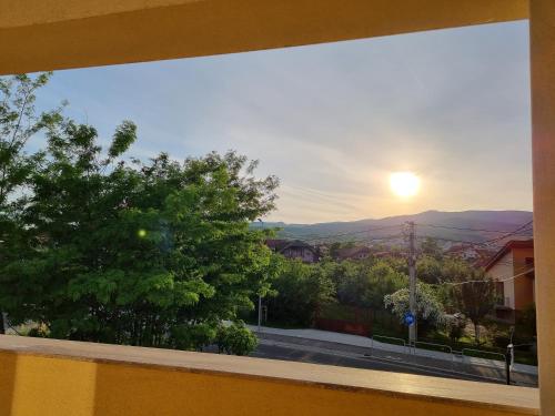 a view from a window of a street with the sunset at Alba Forum in Alba Iulia