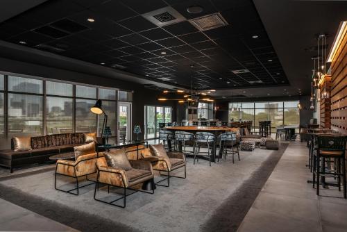 a lobby with couches and tables and a bar at TownePlace Suites by Marriott Nashville Midtown in Nashville