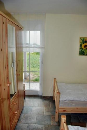 a bedroom with a bed and a large window at "Tau Hus" im "Roden Hus" in Timmendorf