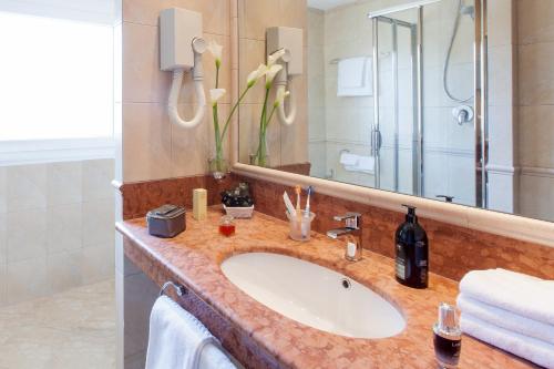 a bathroom with a sink and a shower at Aparthotel Adagio Rome Vatican in Rome