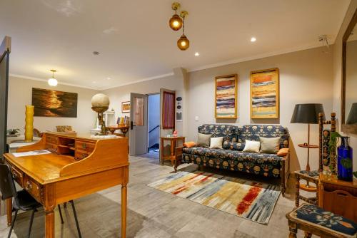 a living room with a piano and a couch at Casa Carmelia La Condesa in Mexico City