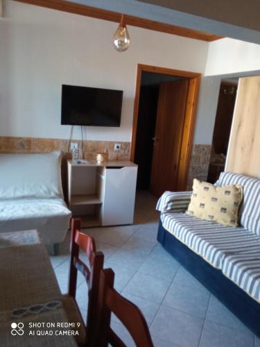 a living room with a couch and a tv at Annas apartment in Sikia