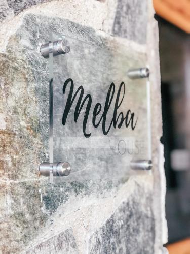 Ein Schild an einer Steinmauer mit dem Wort Melia-Schwein in der Unterkunft Milea Mansion in Limassol