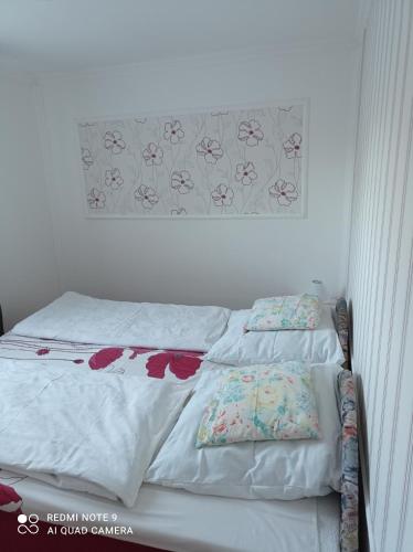 a bed with two pillows on it in a bedroom at Sárgapart Holiday Home in Poroszló