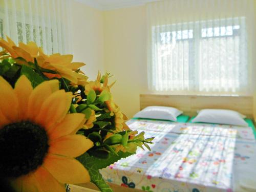 una camera da letto con un letto con un girasole sopra di Sorella a Kostol