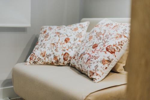 two pillows sitting on top of a couch at Apartamentos MK77 León - Palomera in León