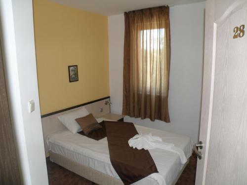 Ένα ή περισσότερα κρεβάτια σε δωμάτιο στο Makao Family Hotel