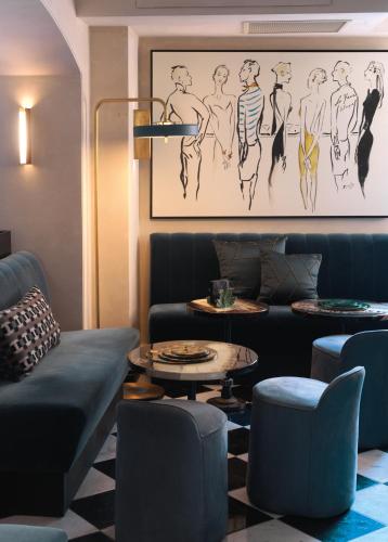 a living room with a couch and a table at Le Yaca Saint-Tropez in Saint-Tropez