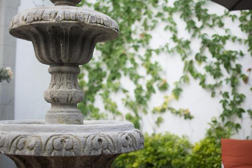 a stone fountain in front of a building at Hotel Casona Independencia in Guadalajara