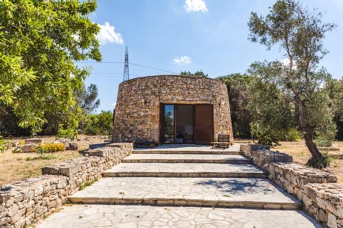 a stone building with a door and some stairs at Tenuta Ferraro Gallipoli in Gallipoli