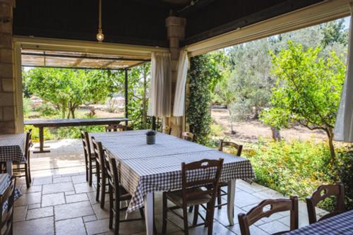a dining room with a table and chairs on a patio at Tenuta Ferraro Gallipoli in Gallipoli
