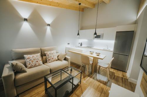 a living room with a couch and a table at Apartamentos MK77 León - Palomera in León