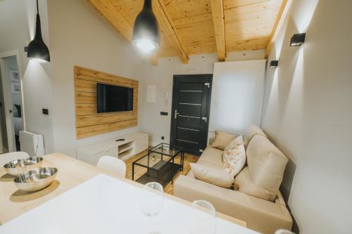 a living room with a couch and a table at Apartamentos MK77 León - Palomera in León