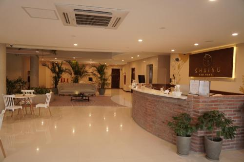 a lobby with a bar and a table and chairs at Chairu Eco Hotel in Santa Cruz de la Sierra