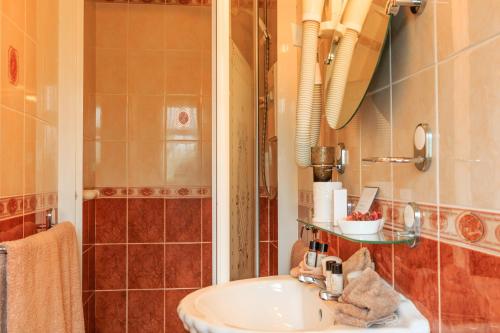 a bathroom with a sink and a shower at Sea Villa in Ardgroom