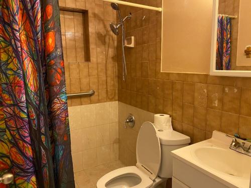 a bathroom with a toilet and a sink at Private Cubicle - Single Bed - Mixed Shared Dorm - MIAMI AIRPORT in Miami