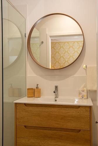 a bathroom with a sink and a mirror at The Old Church Maleny in Maleny