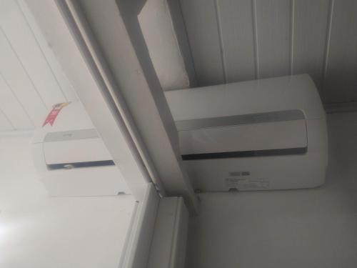 a bathroom with a air conditioner in a room at AP mobiliado em Guaibim in Guaibim