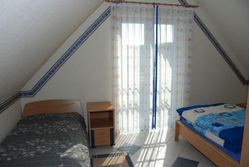 a bedroom with a bed and a large window at Langenwerder in Kaltenhof