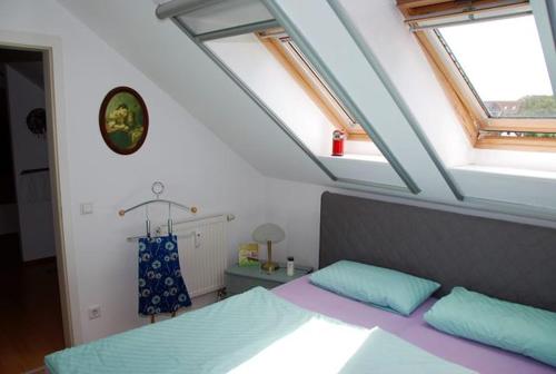 a bedroom with a bed with blue and purple at Schöner Blick in Am Schwarzen Busch