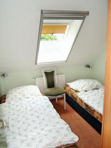 a bedroom with two beds and a window at Seesternchen in Am Schwarzen Busch
