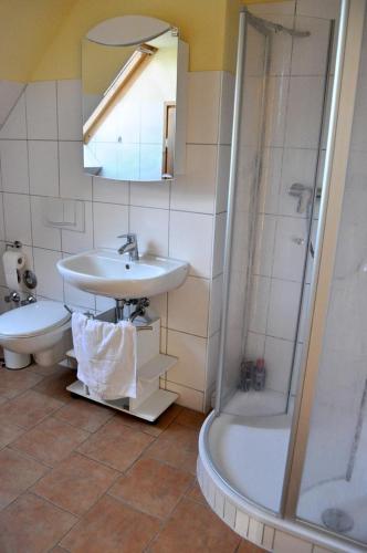 a bathroom with a sink and a shower at Andrea in Timmendorf