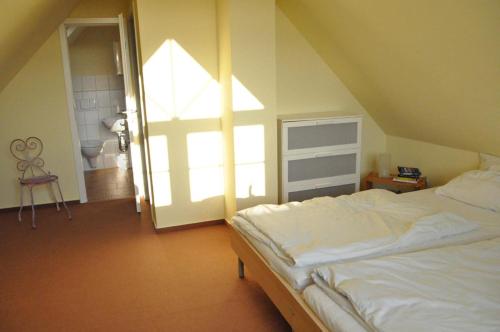 a bedroom with a large white bed and a window at Andrea in Timmendorf