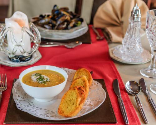 a table with a bowl of soup and a plate of bread at Sea Villa in Ardgroom